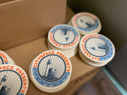 stacks of coasters with CitySpace Presents